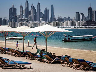 A man walks along the beach at the Anantara The Palm Dubai Resort in Dubai.