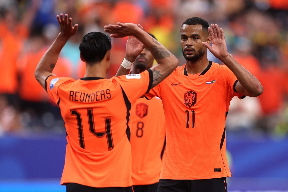Cody Gakpo #11 of the Netherlands celebrates with teammate Tijjani Reijnders #14 after scoring his team's fourth goal during the FIFA World Cup 2026 Group F match between Netherlands and Sweden at Houston Stadium on June 20, 2026 in Houston, Texas.