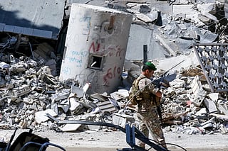 A Lebanese army soldier walks past the rubble of the local branch of the Banque du Liban, Lebanon’s Central Bank, following Israeli bombardment, in Nabatieh in southern Lebanon on June 21, 2026.