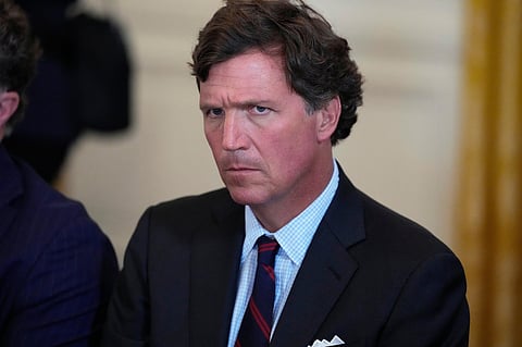 FILE - Tucker Carlson attends a meeting with President Donald Trump and oil executives in the East Room of the White House, Jan. 9, 2026, in Washington.  