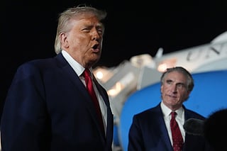 President Donald Trump talks with reporters before boarding Air Force One at John F. Kennedy International Airport in New York, early Tuesday, June 9, 2026, as Interior Secretary Doug Burgum listens. (AP Photo/Mark Schiefelbein)