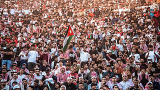 : Jordanian football fans watching on giant screens their national team's 2026 World Cup Group J football match against Algeria at Amman's Roman amphitheatre early on Tuesday.