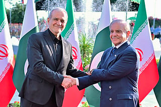 This handout photograph taken on June 23, 2026 and released by Pakistan's Prime Minister's Office shows Iran's President Masoud Pezeshkian (L) shaking hands with Pakistan's Prime Minister Shehbaz Sharif during his ceremonial reception at the Prime Minister House in Islamabad.