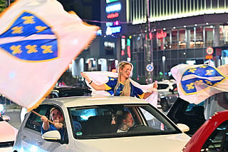 Bosnia and Herzegovina's supporters celebrate in the streets at the end of the Bosnia and Herzegovina World Cup 2026 football match against Qatar in Sarajevo on June 24, 2026.