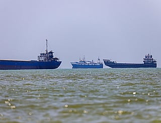 In this picture obtained from Iran's ISNA news agency on June 18, 2026, vessels are seen anchored in Bandar Abbas along the Strait of Hormuz. Oil prices tumbled after Trump and his Iranian counterpart separately signed their accord to end the Middle East war, with the Strait of Hormuz to reopen but two months of negotiations lying ahead. (Photo by AMIRHOSSEIN KHORGOOEI / ISNA / AFP) /