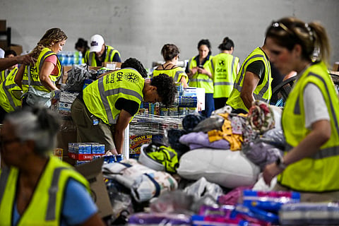Volunteers assemble, sort and pack donations bound for Venezuela as relief organizations work to deliver emergency supplies after two major earthquakes hit northern Venezuela, at the Global Empowerment Mission headquarters in Miami, Florida, on June 25, 2026.