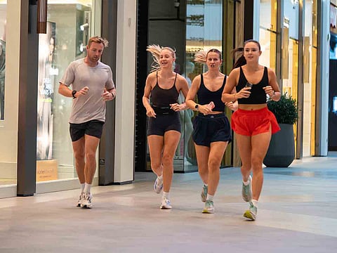Early risers walk and jog inside Dubai's malls as the Dubai Mallathon transforms shopping destinations into vibrant fitness hubs throughout the summer season.