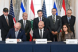 US Secretary of State Marco Rubio (C, back) looks on as (L/R, front row) Israeli Ambassador to the US Yechiel Leiter, State Department Chief of Staff Daniel Holler, and Lebanese Ambassador to the US Nada Hamadeh sign a framework agreement at the US Department of State in Washington, DC, on June 26, 2026.