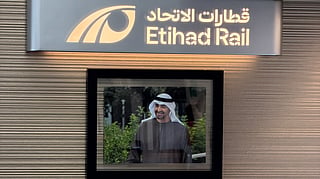 A portrait of President His Highness Sheikh Mohamed bin Zayed Al Nahyan is displayed inside an Etihad Rail passenger train, reflecting the railway's connection to the UAE's national identity and leadership.