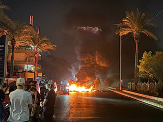 Hezbollah supporters block the old airport road in the southern suburbs of Beirut, with burning tires to protest against the trilateral agreement that was signed between the US, Israel and Lebanon on June 27, 2026. 