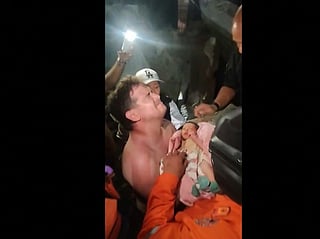A screengrab taken from a video posted on Instagram on June 26, 2026 shows a newborn being pulled out alive from the rubble of the city of La Guaira, Venezuela, after twin earthquakes hit the country.