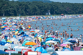 Roskilde festival swelters as Danes flock to water amid record-breaking heat