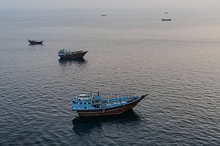 This aerial photograph shows boats anchored off Oman’s northern Musandam Peninsula near the Strait of Hormuz on June 27, 2026.