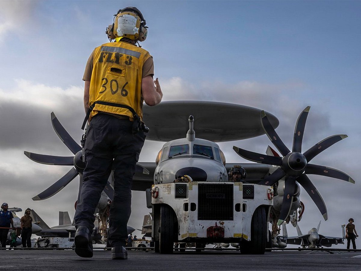 US Sailors prepare an E-2D Hawkeye for flight aboard USS Abraham Lincoln (CVN 72).
