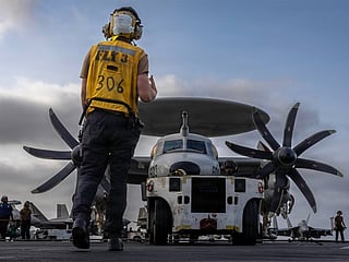 US Sailors prepare an E-2D Hawkeye for flight aboard USS Abraham Lincoln (CVN 72).