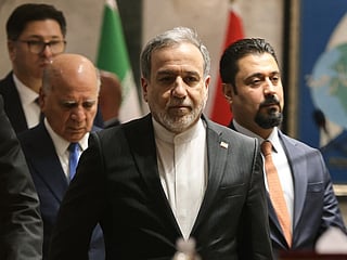 Iranian Foreign Minister Abbas Araqchi (C) followed by Iraqi Foreign Minister Fuad (L) arrive for a joint press conference following a meeting in Baghdad on July 28, 2026.