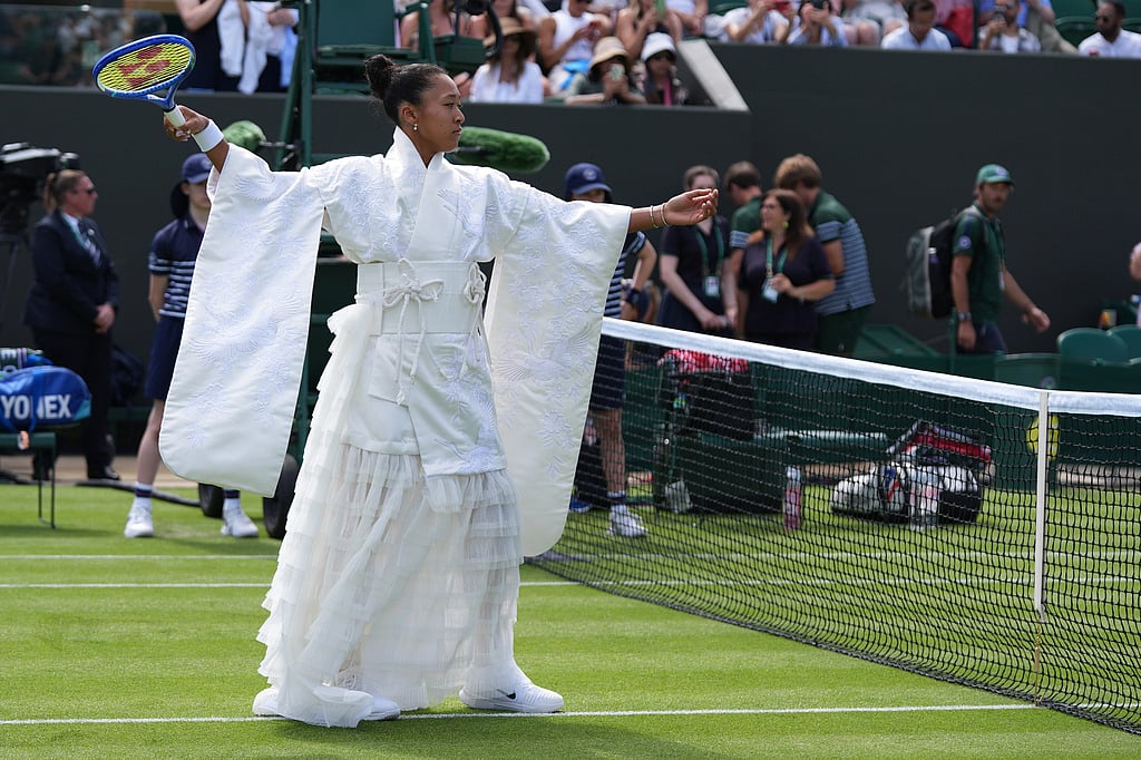 Naomi Osaka of Japan walks into the court to play against Elsa Jacquemot of France in their first round women's singles match at the Wimbledon Tennis Championships in London, Monday, June 29, 2026. (AP Photo/Maja Smiejkowska)