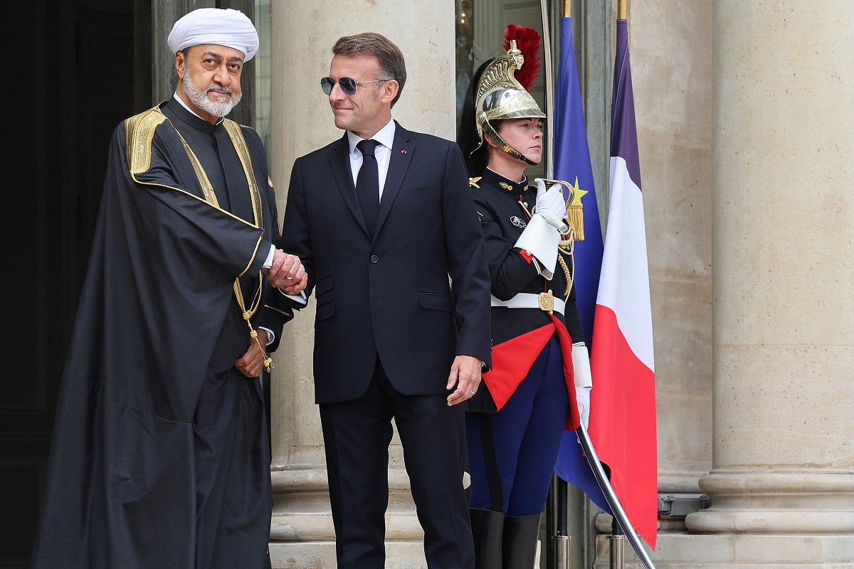 France's President Emmanuel Macron (R) welcomes Oman's Sultan Haitham bin Tarik ahead of a meeting at the Elysee Presidential Palace in Paris on Monday.