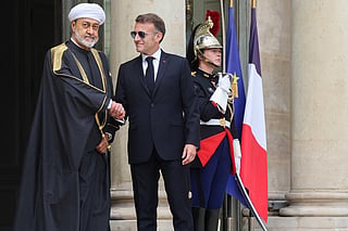 France's President Emmanuel Macron (R) welcomes Oman's Sultan Haitham bin Tarik ahead of a meeting at the Elysee Presidential Palace in Paris on Monday.