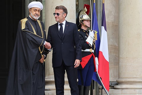 France's President Emmanuel Macron (R) welcomes Oman's Sultan Haitham bin Tarik ahead of a meeting at the Elysee Presidential Palace in Paris on Monday.