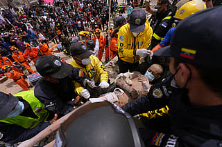 Rescue workers carry a man rescued from the rubble of a building that collapsed in the earthquakes that struck La Guaira, Venezuela, Sunday, June 28, 2026. 