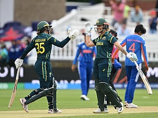 Australia's Georgia Wareham and Australia's Ashleigh Gardner celebrate after beating India 