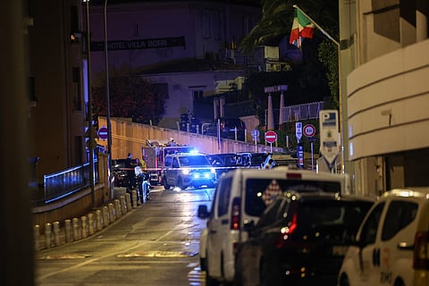 A police car behind a security perimeter on a street following an explosion that occurred in a residential building in Monaco.