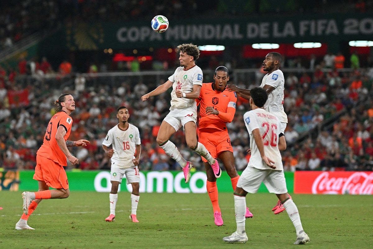 Morocco's midfielder #24 Neil El Aynaoui and Netherlands' defender #04 Virgil van Dijk jump for the ball during the 2026 World Cup round of 32 football match between the Netherlands and Morocco at the Monterrey Stadium in Guadalupe on June 29, 2026.