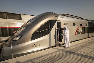 A woman exits the locomotive while touring an Etihad Rail train, the UAE's first passenger train, on its inaugural journey at Mohamed bin Zayed City station in Abu Dhabi on June 30, 2026.