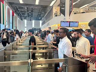 Passengers start lining up to scan their tickets for the next train from Abu Dhabi to Fujairah.