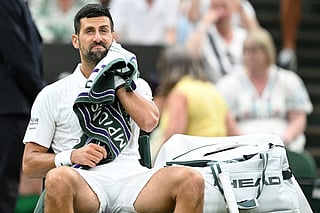 Serbia's Novak Djokovic uses a towel during a break while he plays Greece's Stefanos Tsitsipas during their men's singles second round tennis match on the third day of the 2026 Wimbledon Championships at The All England Lawn Tennis and Croquet Club in Wimbledon, southwest London, on July 1, 2026.