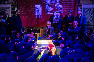Mourners offer prayers beside the coffin of Zahra Haddad Adel, wife of Iran's supreme leader Mojtaba Khamenei, during her funeral in Tehran on July 2, 2026.