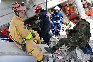 Venezuelan firefighters and rescuers and Brazilian rescuers work on the search of possible survivors in Los Corales, La Guaira state, Venezuela, on July 2, 2026, eight days after twin earthquakes.