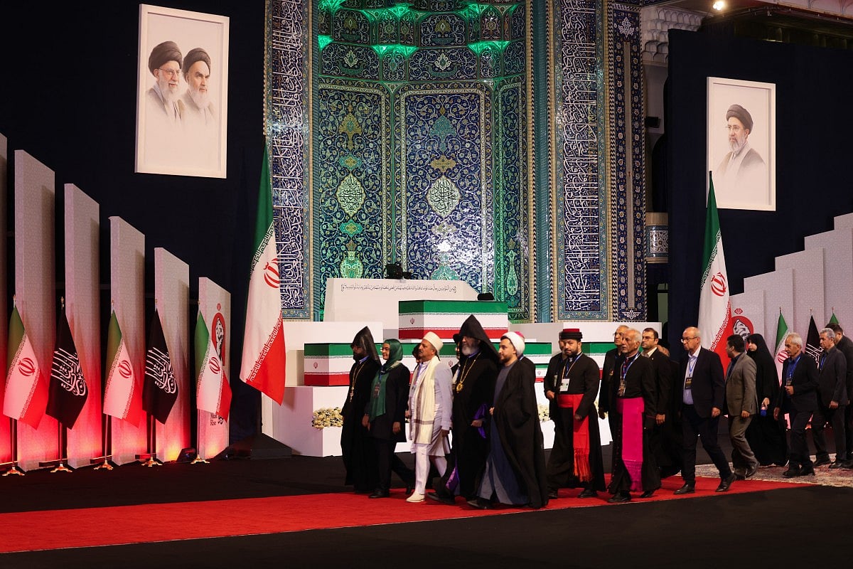Local and foreign officials walk past the coffins of Iran's slain supreme leader Ali Khamenei and his family members after paying their respects at the Grand Mosalla in Tehran on July 3, 2026.