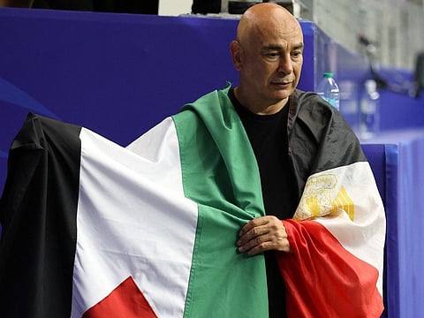 Hossam Hassan, Head Coach of Egypt, holds the flag of Palestine after the team's victory through the penalty shootout during the FIFA World Cup 2026 Round of 32 match against Australia at Dallas Stadium on July 03, 2026 in Arlington, Texas.
