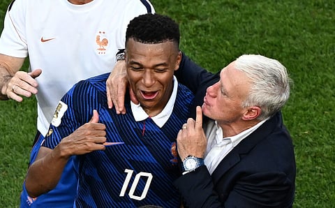 France's forward #10 Kylian Mbappe celebrates with his coach Didier Deschamps after winning the 2026 World Cup round of 16 football match between Paraguay and France at the Philadelphia Stadium in Philadelphia on July 4, 2026.