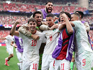 Morocco players celebrate after easing past Canada in the Round of 16 