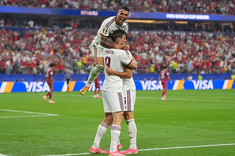 Spain's Pedro Porro, top, congratulates Spain's Mikel Merino, right, after he scored during the World Cup round of 16 soccer match between Portugal and Spain in Arlington, Texas, near Dallas, Monday, July 6, 2026. (AP Photo/Julio Cortez)