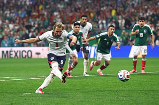 England's Harry Kane converts a second-half penalty to restore his side's two-goal cushion during a dramatic 3-2 victory over Mexico in the FIFA World Cup Round of 16 at Estadio Azteca. Jude Bellingham scored twice before halftime, while England played more than half the second half with 10 men after Jarell Quansah was sent off. Mexico fought back through Julián Quiñones and a late Raúl Jiménez penalty, but the Three Lions held on to seal a quarter-final clash with Norway. After the final whistle, veteran midfielder Jordan Henderson required emergency medical attention and was taken off the pitch on a stretcher following the celebrations.