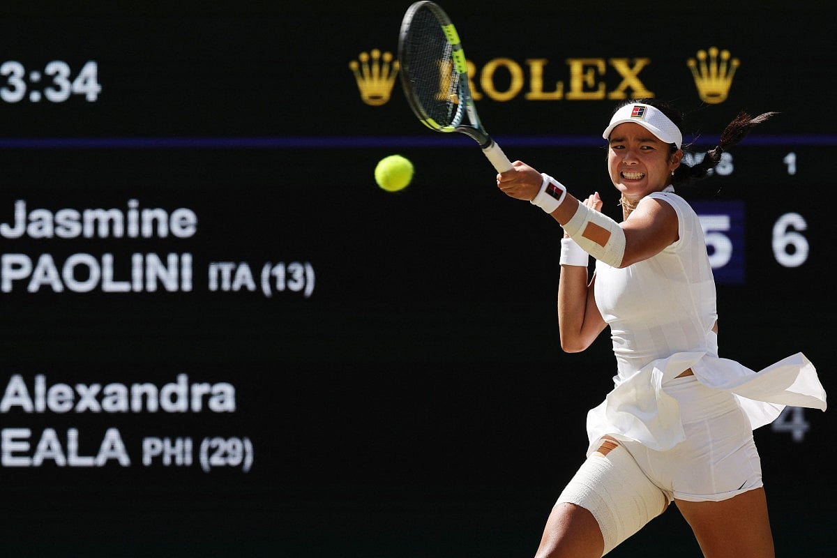 Philippines' Alexandra Eala returns to Italy's Jasmine Paolini during their women's singles round of 16 tennis match on the eighth day of the 2026 Wimbledon Championships at The All England Lawn Tennis and Croquet Club in Wimbledon, southwest London, on July 6, 2026.