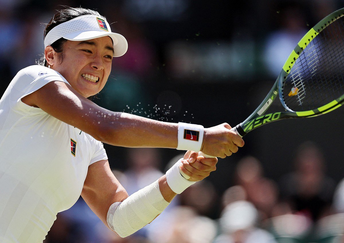 Philippines' Alexandra Eala returns to Italy's Jasmine Paolini during their women's singles round of 16 tennis match on the eighth day of the 2026 Wimbledon Championships at The All England Lawn Tennis and Croquet Club in Wimbledon, southwest London, on July 6, 2026.