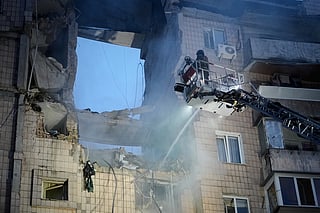 Rescuers work the scene of a building damaged by Russian missile attack in Kyiv, Ukraine, Monday, July 6, 2026. (AP Photo/Efrem Lukatsky)