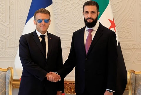 Syria's President Ahmed Al Sharaa (right) with France's President Emmanuel Macron ahead of their meeting at the People's Palace in Damascus on July 7, 2026. 
