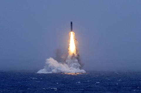 In this photo released by Xinhua News Agency, a long-range ballistic missile bursts out of the sea during a test launched from a Chinese nuclear-powered submarine in the South Pacific on Monday, July 6, 2026.