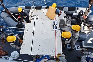 Pakistan Navy and Pakistan Maritime Security Agency personnel transporting the wreckage of the K2 Airways Cargo Boeing 737, after it was recovered.