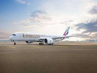 An Emirates Airbus A350 parked at the Dubai Airport tarmac.  