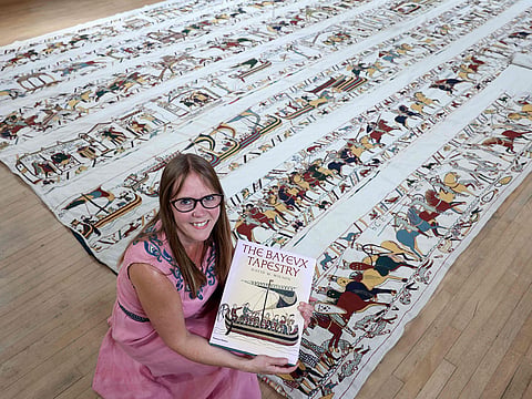 Mia Hansson poses with a large replica of the Bayeux Tapestry, which has been recreated step by step by the former teacher, at a hall in Wisbech, eastern England on July 1, 2026. 