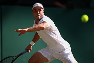Britain's Arthur Fery returns to Italy's Flavio Cobolli during their men's singles quarter-final tennis match on the tenth day of the 2026 Wimbledon Championships at The All England Lawn Tennis and Croquet Club in Wimbledon, southwest London, on July 8, 2026.