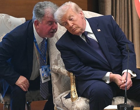 US President Donald Trump confers with an adviser during the Nato summit in Turkey, where he said he believes the US-Iran Memorandum of Understanding is "over" following fresh military exchanges between Washington and Tehran.