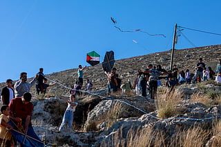 Palestinians and solidartiy activists fly kites towards the Israeli settelment of Har Bracha from the village of Burin, south of Nablus in the occupied West Bank on July 10, 2026.
